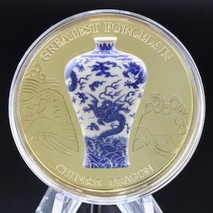 May include: A gold coin with a blue and white porcelain vase with a dragon design. The coin reads "Greatest Porcelain Chinese Dragon".