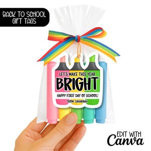 May include: A cellophane bag tied with a rainbow ribbon, containing four coloured highlighters. A gift tag with the text "LET'S MAKE THIS YEAR BRIGHT" and "HAPPY FIRST DAY OF SCHOOL!" is attached. The words "BACK TO SCHOOL GIFT TAGS" are in the upper left corner.