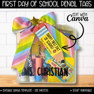 May include: A clear plastic container filled with school supplies and a pencil-shaped tag that reads "Happy First Day of School!" The container is decorated with a rainbow ribbon and a gold star. The name "MS. CHRISTIAN" is printed on the front.