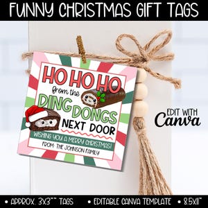 May include: A square Christmas gift tag with a red, white, and green striped border. The tag reads "HO HO HO from the DING DONGS NEXT DOOR" with cartoon illustrations. The tag is tied to a white box with twine and wooden beads.
