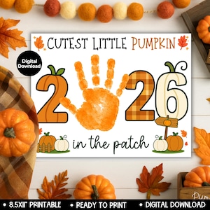 May include: A digital download print featuring the text Cutest Little Pumpkin in the patch with the number 2026, where the zero is replaced by an orange handprint. The design includes pumpkin illustrations, autumn leaves, and a black circle label.