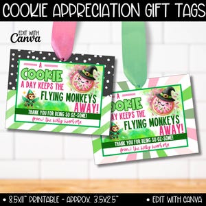 May include: Two printable gift tags featuring a green and pink striped background with a cartoon donut with a witch's hat and a fairy. The text on the tags reads "A cookie a day keeps the flying monkeys away! Thank you for being so oz-some! From the holly heart pla"