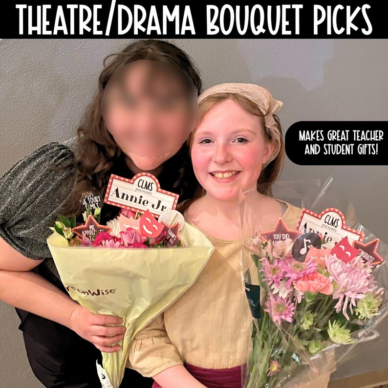 May include: Two bouquets of flowers with colorful decorations, including a red mask, a musical note, and a star. The bouquets are wrapped in yellow paper and have a sign that says "CLMS Presents Annie Jr".