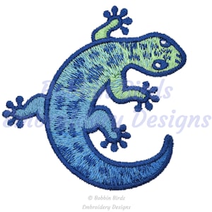 Puede incluir: Diseño de gecko bordado en azul y verde. Este diseño es perfecto para agregar un toque de fantasía a tus proyectos.