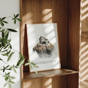 以下が含まれることがあります： 聖書の言葉「それゆえ、これらのわたしの言葉を聞いて行う者は、家を岩の上に建てた賢い人にたとえられる。」マタイ7:24が書かれた、岩の崖の上に建つ家の水彩画の額装です。