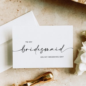 This is a minimalist bridesmaid thank you bifold card written in cursive and sans font. It is blank on the inside so you can write a special note for your bridesmaids!