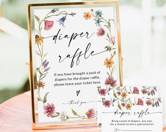 Puede incluir: Un letrero con marco dorado y una tarjeta a juego con detalles florales. El letrero dice "diaper raffle" en escritura elegante, con instrucciones. La tarjeta invita a los invitados a traer pañales para un premio.