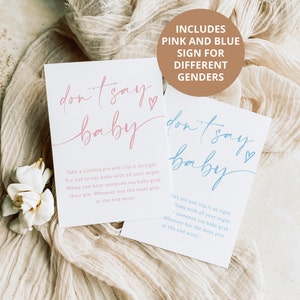May include: Two signs with the text "don't say baby" in pink and blue. The signs are on a beige fabric background. The text "Includes pink and blue sign for different genders" is on a brown rectangle.