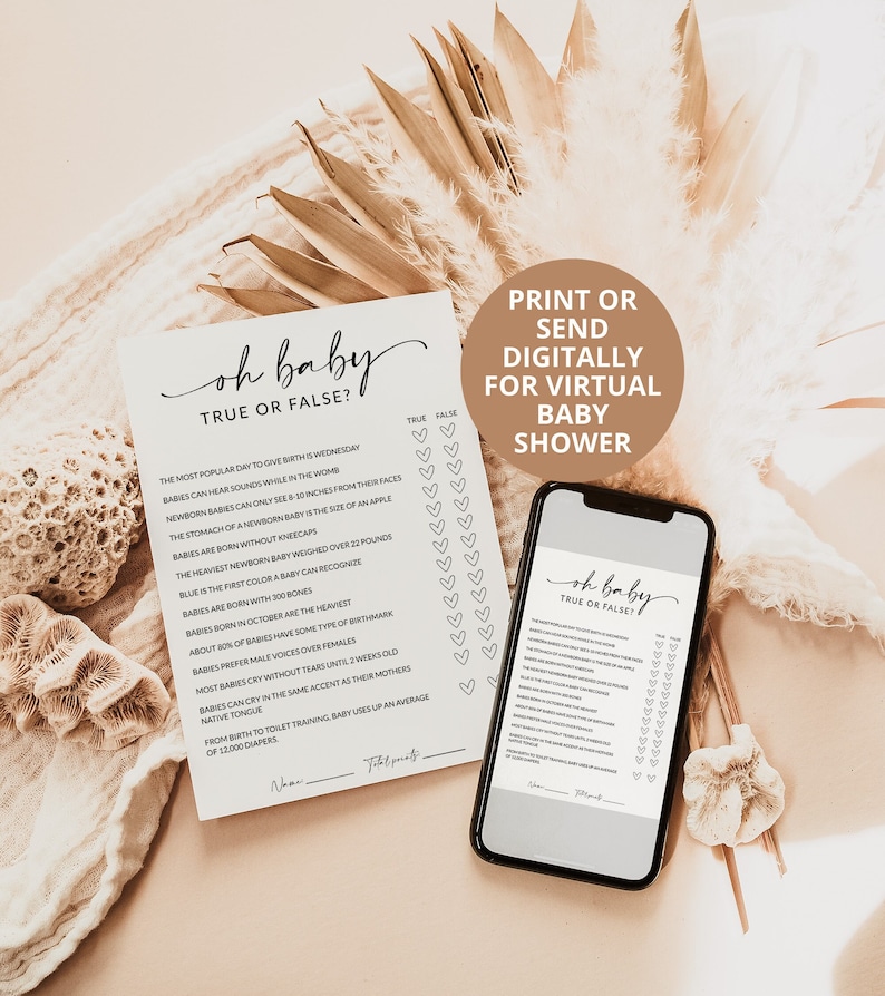 May include: A printed card and a smartphone screen both displaying an Oh Baby True or False baby shower game. The game features a list of trivia questions about infants with heart-shaped checkboxes for True or False answers and a line for a name.