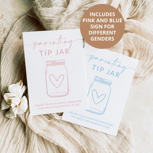 May include: Two signs for a parenting tip jar, one pink and one blue. The signs feature a mason jar with a heart inside. The text on the signs reads "parenting tip jar" and "Share your favorite parenting tips with the parents-to-be."