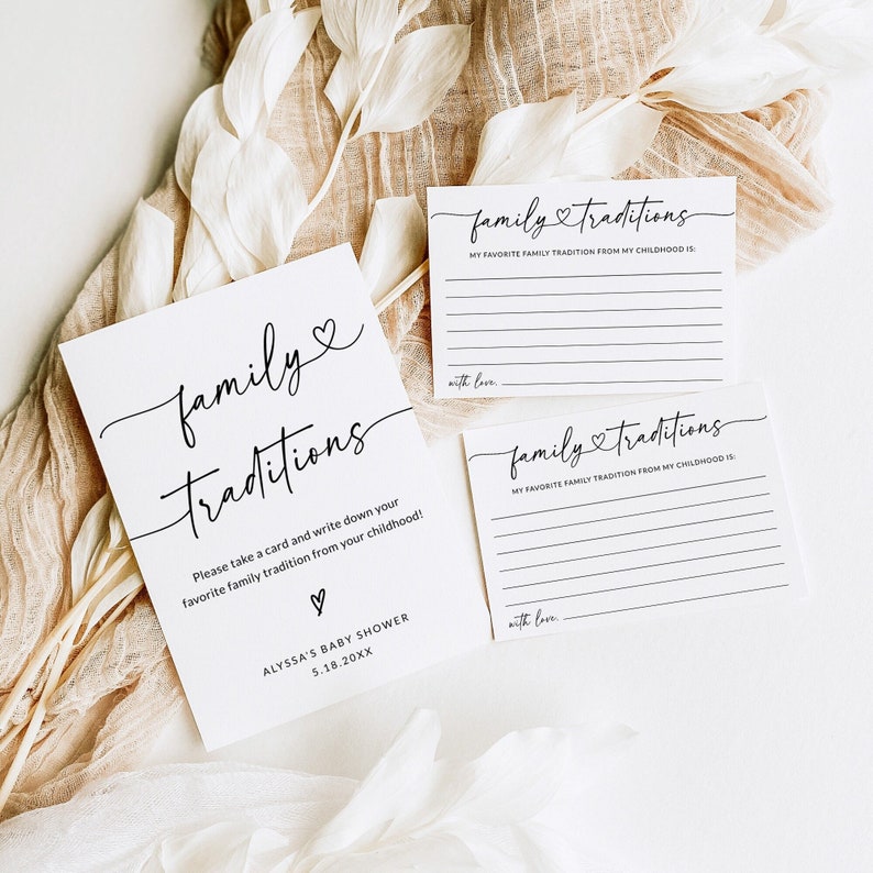 May include: Three white cards with black text that reads "family traditions". The cards are for a baby shower and ask guests to write down their favorite family tradition from their childhood.