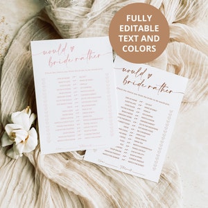 May include: Two printable "Would You Rather" game cards for a bridal shower. The cards are white with pink text and hearts. The text on the cards reads "Would You Rather" and includes a list of questions for guests to answer about the bride.