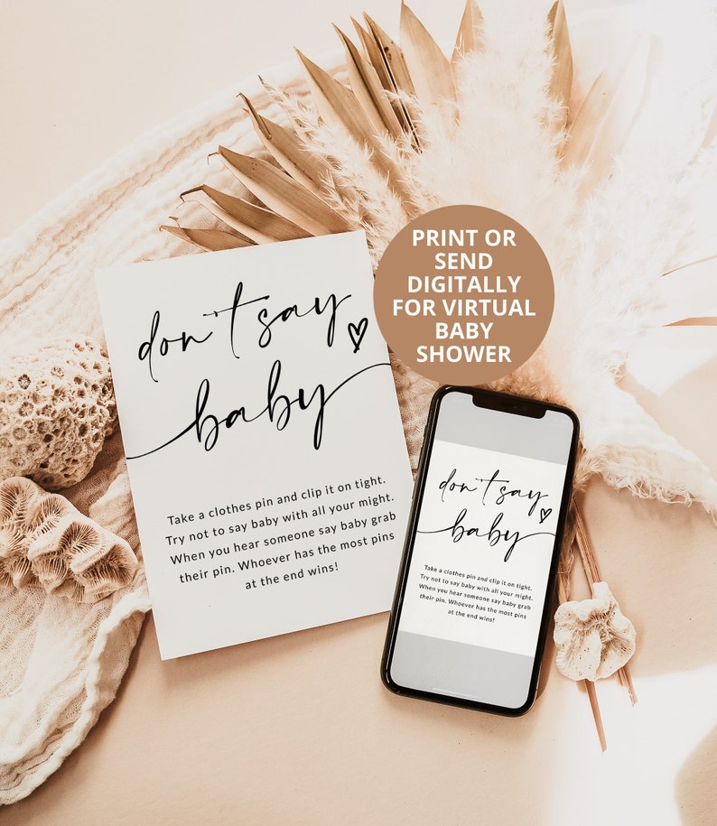 May include: A printable or digital game card for a virtual baby shower. The card has a white background with black text that reads "don't say baby" with a heart symbol. The card instructs players to take a clothes pin and clip it on tight, and try not to say "baby" with all their might. When they hear someone say "baby", they should grab their pin. Whoever has the most pins at the end wins.
