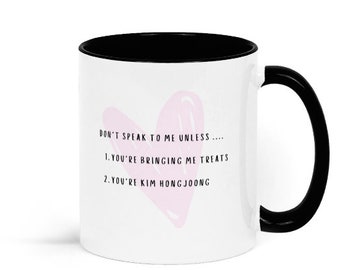 May include: White ceramic mug with a black rim and handle. The mug has a pink heart with the text "DON'T SPEAK TO ME UNLESS.... 1. YOU'RE BRINGING ME TREATS 2. YOU'RE KIM HONGJOONG"