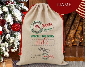 May include: A beige Santa sack with red trim and a drawstring. The sack has the text "Santa Express" and "Special Delivery" with a name field and a "Nice" check box. A Christmas tree and fireplace are in the background.
