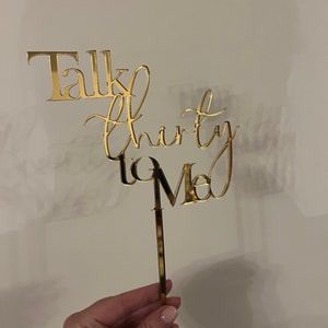 May include: Gold cake topper with the text "Talk Thirty to Me" in a cursive font.
