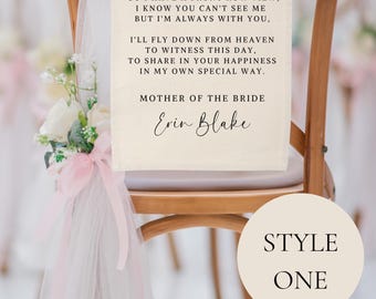 May include: A white chair with a sign that says "Save Me A Seat" with a message from the Mother of the Bride, Erin Blake. The chair is decorated with a pink and white tulle bow.