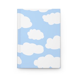 May include: A light blue notebook cover with a white cloud pattern.