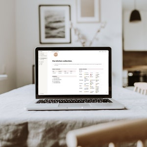 May include: A laptop computer open to a webpage titled "the kitchen collection". The page has a list of items and a calendar with dates and coloured dots.