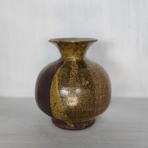 Signed multicolored thrown pottery vessel