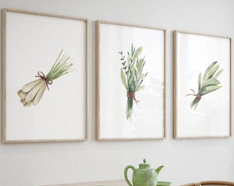 May include: A dining room with a wooden table and chairs, featuring three framed botanical prints of green herbs and a green teapot on the table.