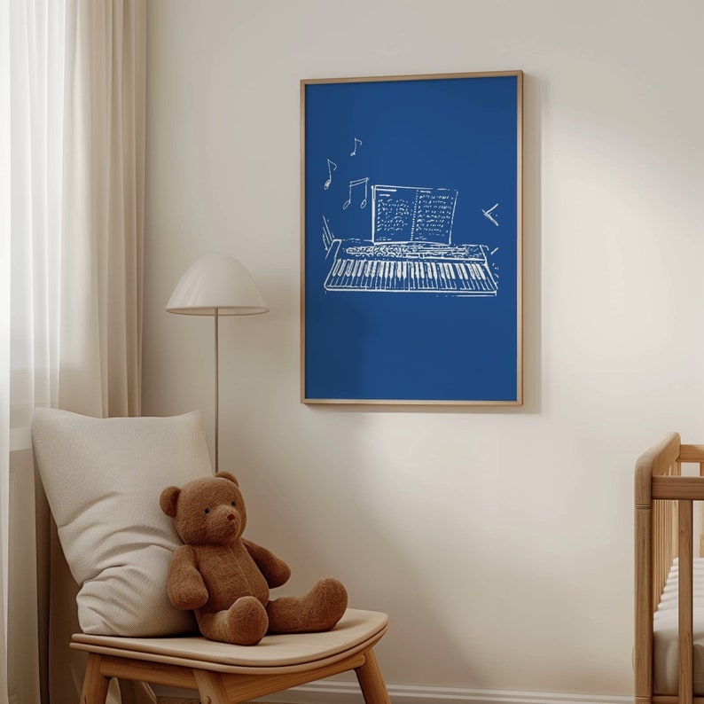 May include: A framed print of a white outline drawing of a keyboard with sheet music on a blue background.