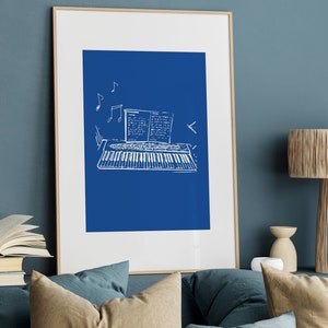 May include: A framed print of a white line drawing of a keyboard with sheet music on a blue background.