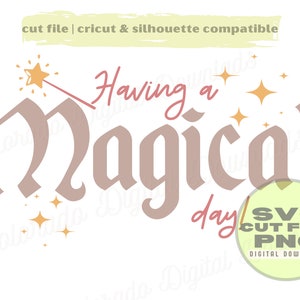 May include: A digital download of a cut file for a Cricut or Silhouette machine. The design features a pink and brown font that says "Having a Magical Day" with a gold star and wand above the text. The design is surrounded by small gold stars.