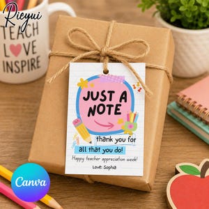 May include: A wrapped brown gift box tied with twine, featuring a tag that reads "JUST A NOTE" with a thank you message. The tag includes a pencil and flower illustrations. A mug with "TEACH LOVE INSPIRE" is visible.