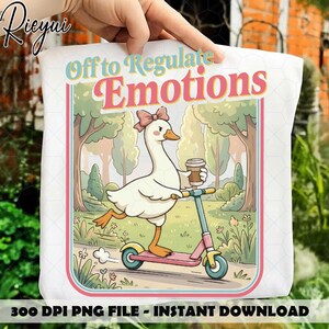 May include: White tote bag with a cartoon goose on a pink scooter, holding a coffee. Text reads "Off to Regulate Emotions". The design is framed with pink and blue borders. The bottom of the bag reads "300 DPI PNG FILE - INSTANT DOWNLOAD".