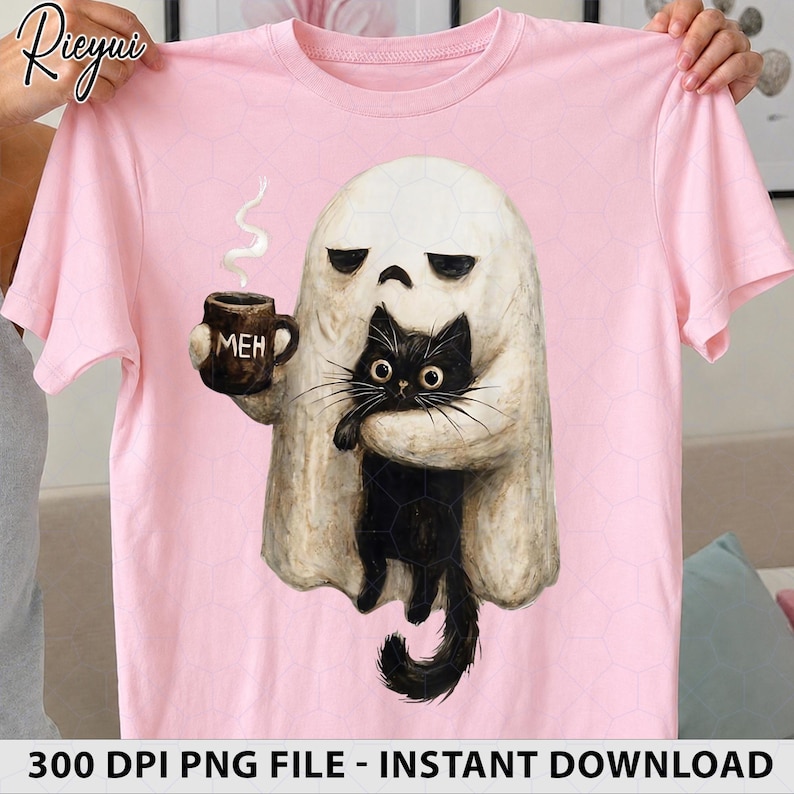 May include: A light pink short-sleeve t-shirt featuring a graphic of a white ghost with a bored expression holding a brown mug with the text MEH and a black cat. The ghost has a rounded shape and the cat has large eyes and long whiskers.