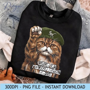 May include: Black sweatshirt featuring a detailed illustration of a brown and tan cat wearing a green beret and raising a paw. The text "VIVA LA REVOLUCION CARL" is printed below the cat. The sweatshirt is a PNG file available for instant download.