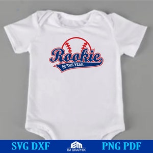 May include: White baby onesie with a red, white, and blue baseball graphic and the text "Rookie of the Year".