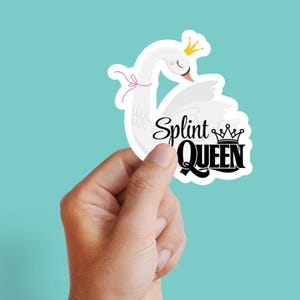 May include: A white sticker featuring a swan wearing a crown and a pink bow. The sticker has the text "Splint QUEEN" in a black, stylized font. The background is a solid teal color.