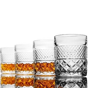 May include: Set of four clear glass whiskey tumblers with a diamond-cut pattern. The glasses are filled with amber liquid.