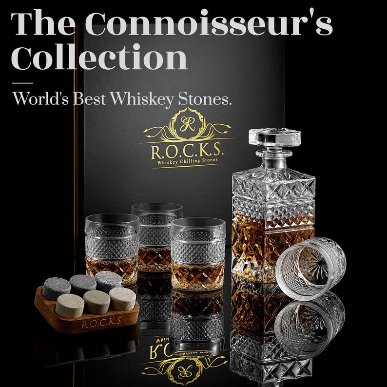 May include: A set of whiskey stones, a decanter, and four glasses with a diamond pattern. The set is on a black surface with a box that says "World's Best Whiskey Stones." and "R.O.C.K.S. Whiskey Chilling Stones."
