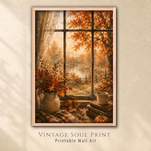 May include: A framed wall art print titled VINTAGE SOUL PRINT Printable Wall Art, depicting a window view of an autumn landscape with orange trees, a lake, and a fence. A ceramic vase with fall foliage, a mug, books, and a pumpkin sit on the sill.