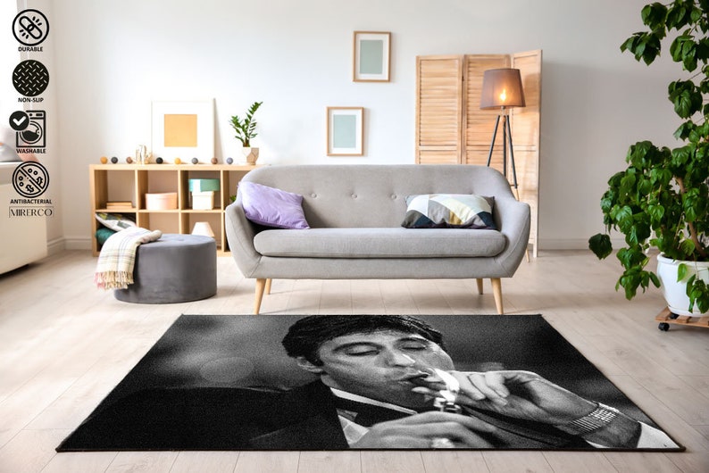 May include: Black and white rug featuring a close-up image of a man smoking a cigarette. The man is wearing a suit and has a serious expression on his face.