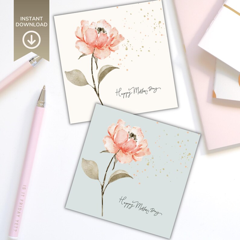 Two square greeting cards featuring a watercolor pink floral design with green leaves, displayed on a styled desk background with stationery accessories.