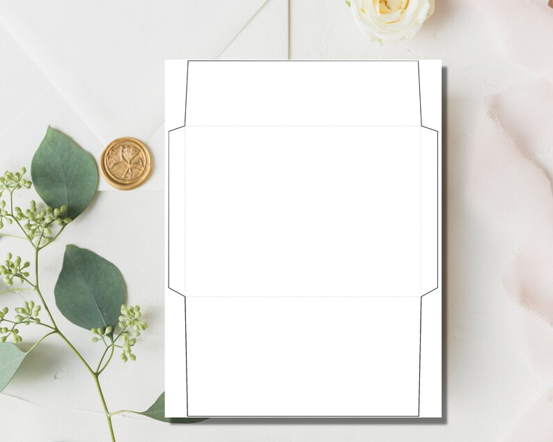 Envelope template displayed on a white surface with a gold wax seal, greenery, and a white flower in a clean flat lay style.
