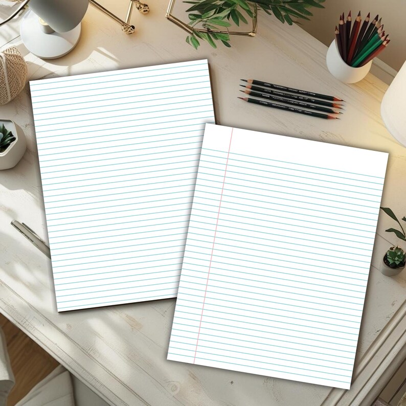 Two blue lined writing paper sheets, one with narrow lines and one with wider lines, displayed on a light desk with pencils, plants, and office items around them.