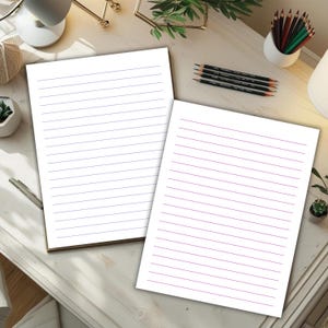 Two pastel lined note pages are displayed on a desk, one with blue lines and one with pink lines, surrounded by pencils and light decor.