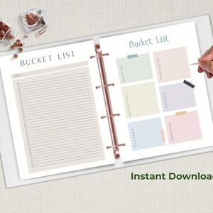 Open ring binder planner showing two bucket list pages with checklist lines and colorful note boxes while a hand holds a pencil above the page.