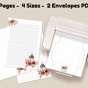Fall stationery set with lined pages and matching envelopes featuring lantern and floral designs, shown printing from a home printer.