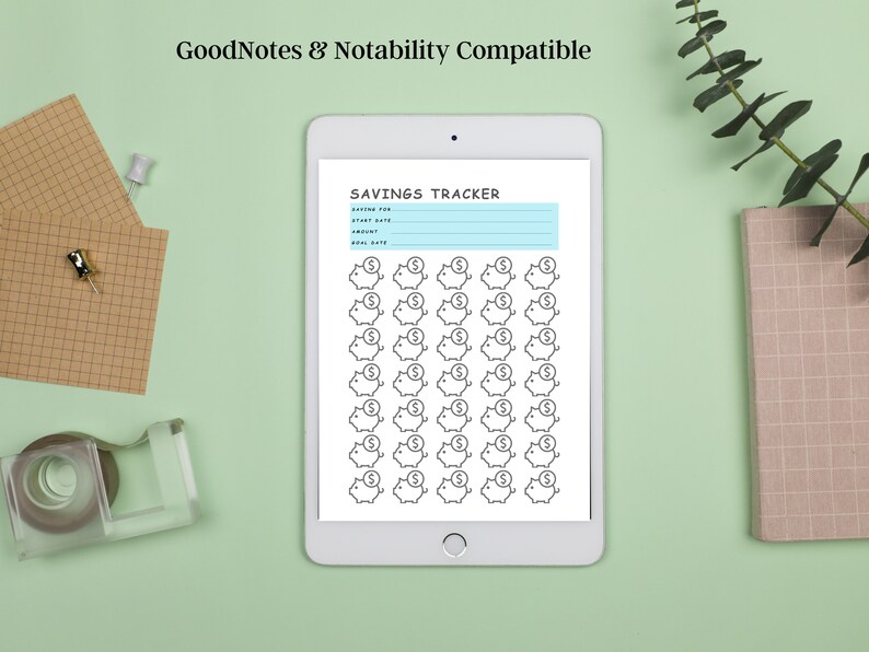 May include: A digital savings tracker on a white tablet with a light blue background. The tracker has a section for saving for, start date, amount, and goal date. There are 49 piggy bank icons with dollar signs on top.
