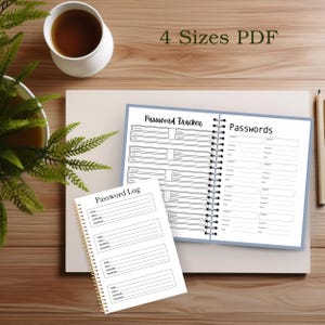 Open notebook and spiral-bound pages showing password log and password tracker layouts on a wooden desk with a coffee mug, green plant, and neutral workspace accessories.