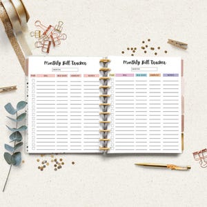 Monthly bill tracker displayed inside a planner style binder on a neutral desk background.