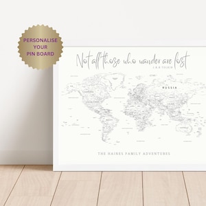May include: A white world map with black text and borders. The map is framed in a white frame. The text "Not all those who wander are lost" is at the top of the map, with the author "J.R.R TOLKIN" below. The text "THE HAINES FAMILY ADVENTURES" is at the bottom of the map.
