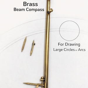 May include: An adjustable brass beam compass with the text "Brass Beam Compass" and "For Drawing Large Circles or Arcs". The compass is gold-colored and includes two additional points. The bottom of the image has the text "Adjustable Brass Beam Compass".
