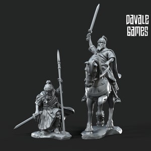 May include: Two gray plastic miniature figures of warriors, one on horseback, the other standing with a spear. The figure on horseback is holding a sword in the air. The text "Davale Games" is visible in the background.